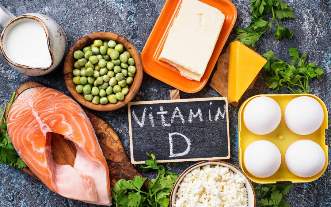 Assortment of Vitamin D-rich foods with a slate displaying 'Vitamin D'.