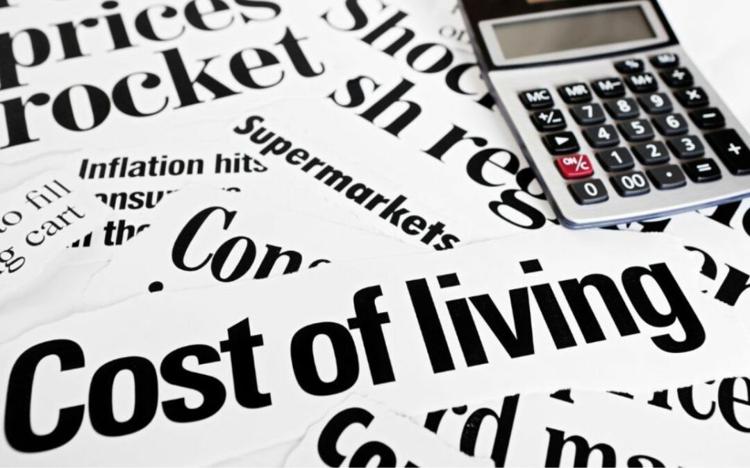 Newspaper headlines about the cost of living crisis with a calculator.